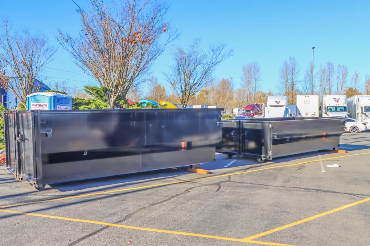 Professional dumpster rental service with roll-off container on residential driveway in Silver Lake